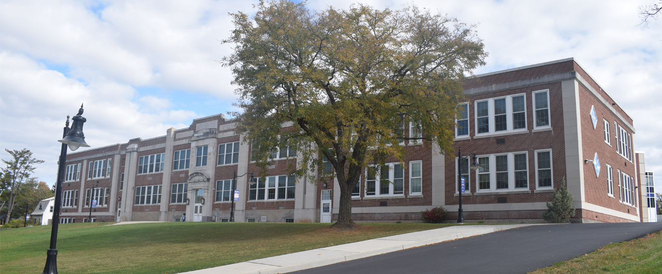 Image of a stately building with a tree in front